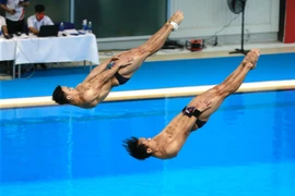 Hai vận động viên Malaysia Chew Yyi Wei và Ooi Tze Liang thực hiện phần thi. (Ảnh: Trọng Đạt/TTXVN)