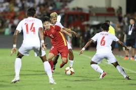 Phan Tuấn Tài (12) tả xung hữu đột trong vòng vây các cầu thủ U23 Myanmar. (Ảnh: Minh Quyết/TTXVN)