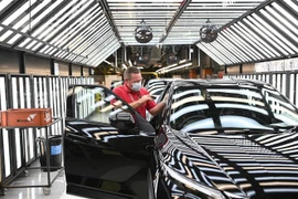 Nhân viên hãng Nissan hoàn tất công đoạn sản xuất xe ô tô tại nhà máy của Công ty ở Sunderland, Đông Bắc Anh. (Ảnh: AFP/TTXVN)