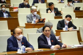 Chủ tịch nước Nguyễn Xuân Phúc, Thủ tướng Chính phủ Phạm Minh Chính và các đại biểu Quốc hội dự phiên họp sáng 7/1. 