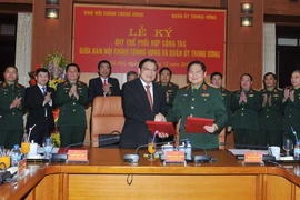 Đại tướng Ngô Xuân Lịch và ông Phan Đình Trạc, Phó trưởng Ban Thường trực Ban Nội Trung ương ký Quy chế phối hợp công tác. (Ảnh: Trọng Đức/TTXVN)