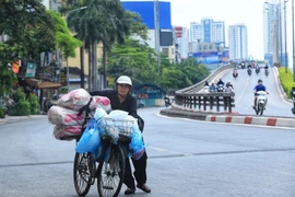 Một người dân thu mua phế liệu mưu sinh dưới trời nắng nóng. (Ảnh: Tuấn Anh/TTXVN) 