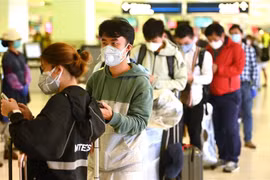 Hành khách đeo khẩu trang phòng lây nhiễm COVID-19 tại sân bay quốc tế ở Sydney, Australia, ngày 18/3/2020. (Nguồn: AFP/TTXVN) 