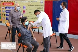 Nhân viên y tế tiêm vaccine phòng COVID-19 cho người dân tại Iran. (Ảnh: IRNA/TTXVN) 