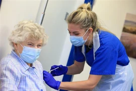 Một cụ bà được tiêm vaccine ngừa COVID-19. (Nguồn: AFP/TTXVN) 