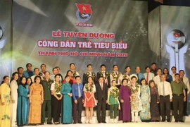 Lãnh đạo Thành phố cùng các gương công dân trẻ tiêu biểu được vinh danh tại chương trình. (Ảnh: Hồng Giang/TTXVN) 