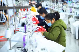Công nhân làm việc bên trong một xưởng may ở tỉnh Hồ Bắc, Trung Quốc ngày 13/3/2020. (Nguồn: THX/TTXVN) 