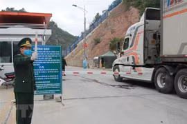 Cán bộ biên phòng Tân Thanh điều tiết xe nông sản xuất khẩu. (Ảnh: Quang Duy/TTXVN) 