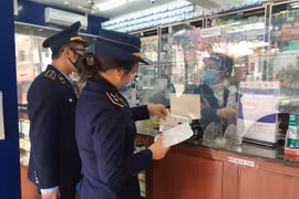 Cục Quản lý thị trường Quảng Ninh kiểm tra hoạt động kinh doanh kit test nhanh và thuốc điều trị COVID-19 tại một cơ sở bán thuốc. (Ảnh: TTXVN phát) 