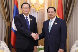 Thủ tướng Phạm Minh Chính và Thủ tướng Lào Sonexay Siphandone. (Ảnh: Dương Giang/TTXVN)