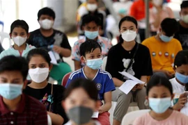 Học sinh chờ tiêm vaccine ngừa COVID-19 tại Phnom Penh, Campuchia. (Ảnh: AFP/TTXVN) 
