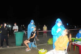 Lực lượng y tế xét nghiệm người dân, công nhân khu vực phát hiện ca dương tính. (Ảnh: K GỬIH/TTXVN) 