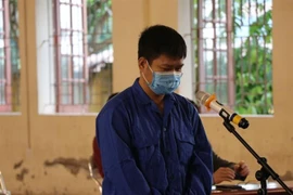Bị cáo Lê Quang Huy tại phiên tòa. (Ảnh: Mạnh Minh/TTXVN) 