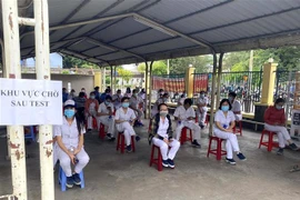 Công nhân Công ty trách nhiệm hữu hạn Nagata Việt Nam tại Khu chế xuất Tân Thuận, quận 7 được lấy mẫu xét nghiệm COVID-19. (Ảnh: TTXVN phát) 