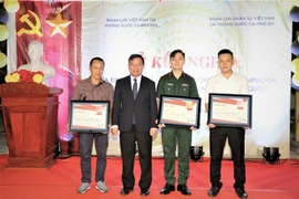Đại sứ Nguyễn Huy Tăng (thứ hai, từ trái sang) trao giải cho đại diện các đội bóng đoạt giải trong giải bóng đá giao hữu. (Ảnh: Hoàng Minh/TTXVN)