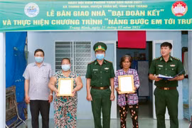 Lãnh đạo Bộ đội Biên phòng Sóc Trăng và Mặt trận Tổ quốc Việt Nam tỉnh bàn giao nhà Đại đoàn kết cho hộ nghèo tại xã Trung Bình, huyện Trần Đề. (Ảnh: Trung Hiếu/TTXVN) 