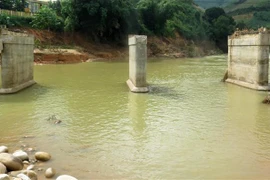 Trong đợt mưa lũ vừa qua, 2 nhịp cầu dân sinh tại xã Sơn Dung, huyện Sơn Tây (Quảng Ngãi) bị nước lũ cuốn chia cắt nhiều khu dân cư. (Ảnh: Lê Ngọc Phước/TTXVN) 