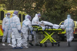 Nhân viên y tế chuyển bệnh nhân nhiễm COVID-19 tới bệnh viện ở Prague, Cộng hòa Séc. (Ảnh: AFP/TTXVN) 