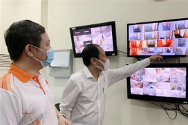 Ông Dương Anh Đức, Phó Chủ tịch UBND Thành phố Hồ Chí Minh, kiểm tra việc tổ chức hoạt động cách ly có thu phí cho người nhập cảnh thông qua hệ thống camera giám sát tại khách sạn Norfolk (Quận 1). (Ảnh: Đinh Hằng/TTXVN)