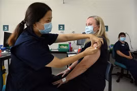Tiêm chủng vaccine phòng COVID-19 tại Sydney, Australia. (Ảnh: AFP/TTXVN)