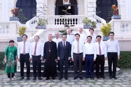 Phó Thủ tướng Trần Lưu Quang chụp ảnh cùng Tổng Giám mục Nguyễn Năng, Chủ tịch Hội Giám mục Việt Nam, Tổng Giám mục Tổng Giáo phận Thành phố Hồ Chí Minh. (Ảnh: Xuân Khu/TTXVN)