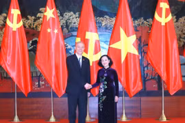 Thường trực Ban Bí thư Trương Thị Mai làm việc với Ủy viên Ban Thường vụ Bộ Chính trị Đảng Cộng sản Trung Quốc Thái Kỳ. (Ảnh: Phương Hoa/TTXVN)