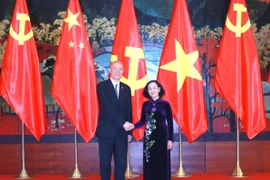 Thường trực Ban Bí thư Trương Thị Mai làm việc với Ủy viên Ban Thường vụ Bộ Chính trị Đảng Cộng sản Trung Quốc Thái Kỳ. (Ảnh: Phương Hoa/TTXVN)