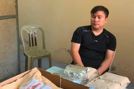 Phạm Văn Trung cùng tang vật gần 7kg ma túy bị công an thu giữ. (Ảnh do công an cung cấp)