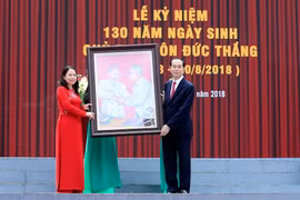 Chủ tịch nước Trần Đại Quang tặng bức tranh Bác Hồ với Bác Tôn cho Đảng bộ, chính quyền và nhân dân các dân tộc tỉnh An Giang. (Ảnh: Nhan Sáng/TTXVN)