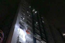 Lực lượng phòng cháy chữa cháy thực hiện công tác cứu hộ, đưa người dân ra khỏi hiện trường vụ cháy. (Ảnh: Linh Sơn/TTXVN)