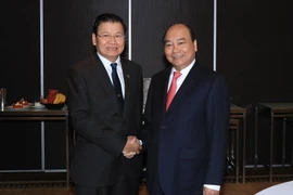 Sáng 17/3/2018, tại Thành phố Sydney, Thủ tướng Nguyễn Xuân Phúc gặp Thủ tướng Lào Thongloun Sisoulith. (Ảnh: Thống Nhất/TTXVN)