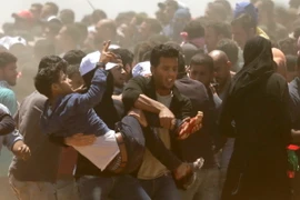 Chuyển người biểu tình Palestine bị thương sau các cuộc đụng độ với binh sỹ Israel tại khu vực biên giới Dải Gaza với Israel ngày 14/5. (Nguồn: AFP/TTXVN)