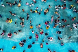 Người dân tránh nóng dưới bể bơi tại Bulacan, Philippines, ngày 5/5/2024. (Ảnh: THX/TTXVN)