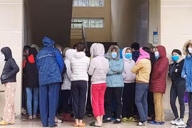 Công nhân chen nhau làm thủ tục xét nghiệm nhanh tại trạm y tế phường Bình Minh, thị xã Nghi Sơn (Thanh Hóa). (Ảnh: Trịnh Duy Hưng/TTXVN)