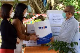 Đại diện Cơ quan TTXVN khu vực miền Trung-Tây Nguyên trao tặng các phần quà cho Ni cô Thích Nữ Minh Tịnh, trụ trì chùa Quang Châu. (Ảnh: Quốc Dũng/TTXVN)