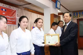Công sứ Hoàng Xuân Hải đang trao Bằng chứng nhận cho 6 học viên xuất sắc của lớp họp tiếng Việt nâng cao khóa 1. (Ảnh: Phạm Kiên/Vietnam+)