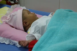 Cháu bé bị gãy chân hiện đang được chăm sóc tại Bệnh viện đa khoa Nhật Tân, thành phố Châu Đốc, tỉnh An Giang. (Ảnh: Công Mạo/TTXVN)