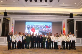 Đại sứ Lê Quý Quỳnh, Thứ trưởng Quốc phòng Malaysia Lew Chin Tong chụp ảnh cùng Đoàn Tùy viên Quân sự tại Malaysia tham dự sự kiện. (Ảnh: Nhương-Ngọc-Tuân/Vietnam+)