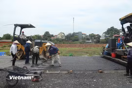 Nhà thầu thi công bảo trì một tuyến đường bộ. (Ảnh: Việt Hùng/Vietnam+)