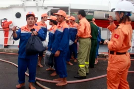 Thuyền viên tàu cá BĐ 98079 TS được đưa vào bờ an toàn. (Ảnh: Phan Sáu/TTXVN)