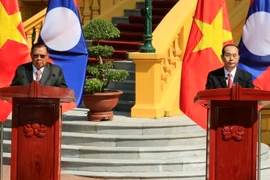 Chủ tịch nước Trần Đại Quang và Tổng Bí thư, Chủ tịch nước Lào Bounnhang Vorachith đồng chủ trì buổi họp báo kết thúc Năm đoàn kết hữu nghị Việt Nam-Lào, Lào-Việt Nam. (Ảnh: Nhan Sáng/TTXVN)