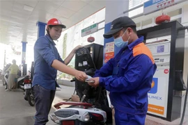 Mua bán xăng, dầu tại cửa hàng kinh doanh của Petrolimex trên phố Lạc Trung, Hai Bà Trưng, Hà Nội. (Ảnh: Trần Việt/TTXVN)