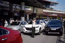 Lực lượng an ninh sân đỗ ôtô tăng cường điều tiết phương tiện ra, vào Cảng hàng không quốc tế Nội Bài. (Ảnh: CTV/Vietnam+)