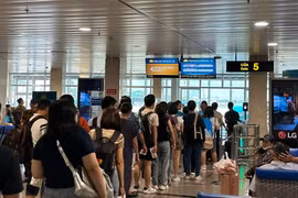 Hành khách làm thủ tục lên chuyến bay tại Cảng Hàng không quốc tế Tân Sơn Nhất. (Ảnh: PV/Vietnam+)