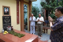 Tác giả kịch bản "Làm đĩ" cùng con rể và cháu của nhà văn Vũ Trọng Phụng bên mộ nhà văn chiều 12/5/2011 (ảnh: Nguyễn Anh/ Vietnam+)