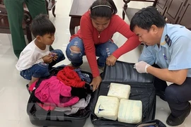 Đối tượng và tang vật tại Chi cục Hải quan cửa khẩu Mộc Bài, ngày 3/12 (Ảnh: Lê Đức Hoảnh/TTXVN)