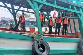 Lực lượng biên phòng kiểm tra một tàu cá. (Ảnh: Huỳnh Anh/TTXVN)