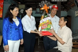 Thăm và tặng quà Tết cho thương binh 1/4 Lê Thanh Cần cùng người con là nạn nhân chất độc da cam ở ấp Ba Sa, xã Phước Hiệp, huyện Củ Chi. (Ảnh: Thanh Vũ/TTXVN)