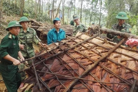 Bộ đội Biên phòng Quảng Bình giúp dân dựng lại nhà cửa, khắc phục hậu quả do lốc xoáy mưa đá gây ra. (Ảnh: Mạnh Thành/TTXVN)