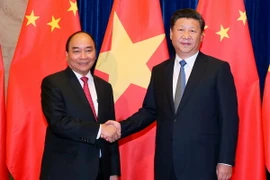 Thủ tướng Nguyễn Xuân Phúc hội kiến với Tổng Bí thư, Chủ tịch nước Trung Quốc Tập Cận Bình. (Ảnh: Thống Nhất/TTXVN)